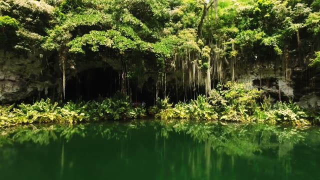 The Camera Flies To The Entrance Of The Cave Above The Lake
