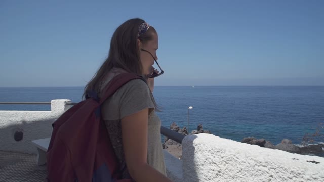 Girl Standing On The Balcony And Looking At The Sea
