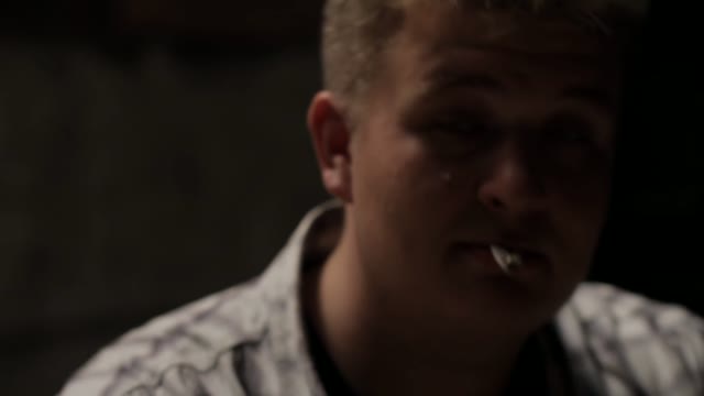 Man Spits Out A Cigarette Close-up
