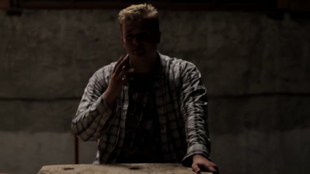 Man Smokes In A Dark Room
