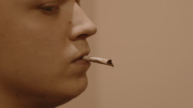 Man Says With A Cigarette In His Mouth Close-up
