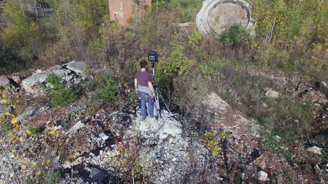 Man Standing With Film-making Equipment