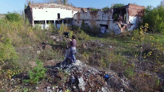 Man Standing With Film-making Equipment