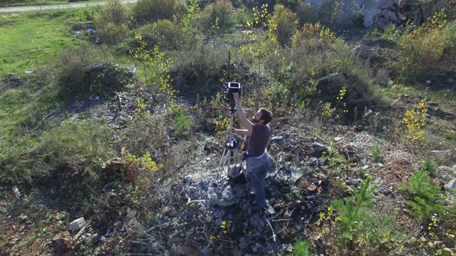 Man Standing With Film-making Equipment