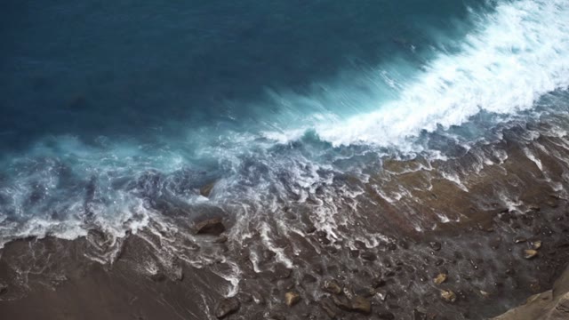 Sea Waves Beat Against The Stone Beach