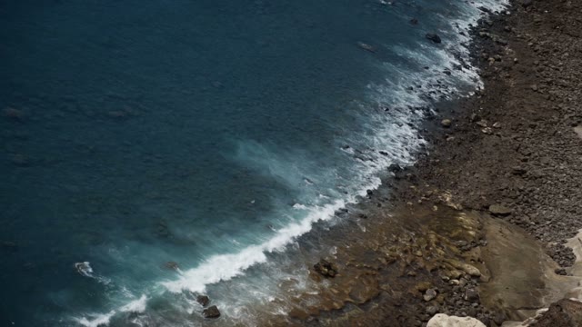 Blue Sea Waves Beat Against The Beach