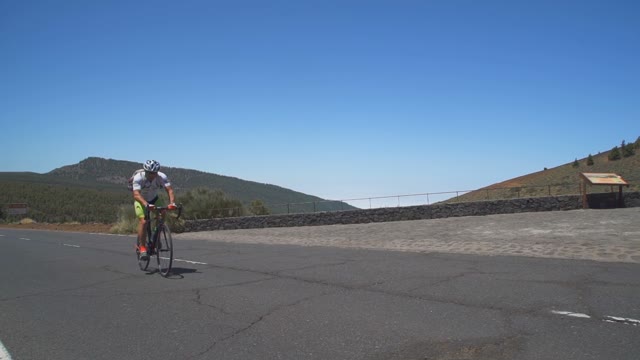 A Cyclist Rides Up The Mountain