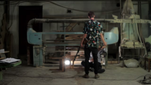 Men With A Shotgun Moving Away From The Wounded Man