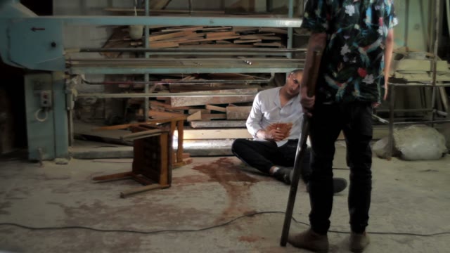 Men With A Shotgun Moving Away From The Wounded Man