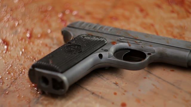 Pistol In Blood Close-up