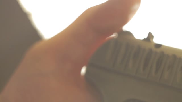 Man Cocks The Gun Close-up
