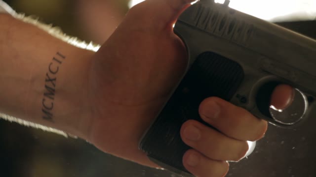 Man Cocks The Gun Close-up