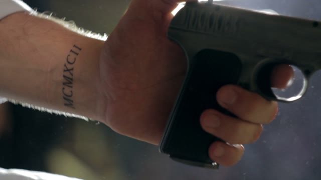Man Cocks The Gun Close-up