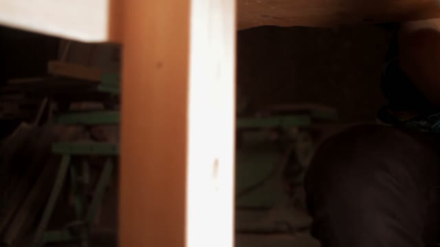 Man Holding The Shotgun Under The Table Close-up