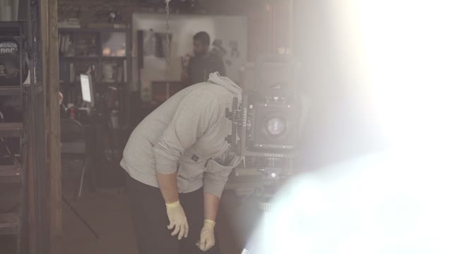 Man Photographs On A Retro Camera