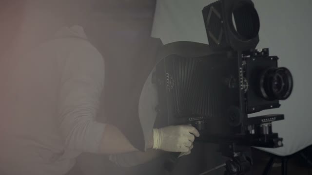 Man Photographs On A Retro Camera Close-up
