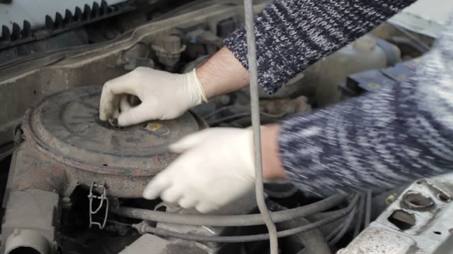 Man Pulls Out A Ring Air Filter From A Car Close-up