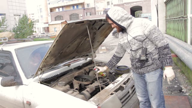 Man Sprinkles Car Engine