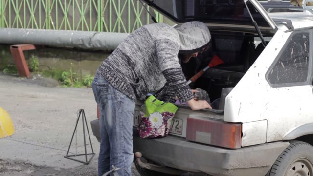 Man Cleans In The Trunk Of A Car