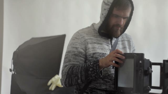 Man Dismantles A Camera Close-up