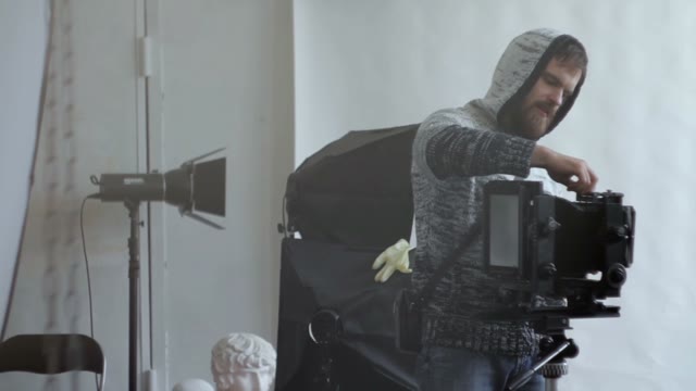 Man Dismantles A Camera Close-up