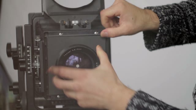 Man Removes Camera Lens Close-up