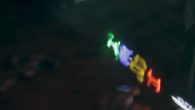 Neon Sign In The Reflection In A Puddle