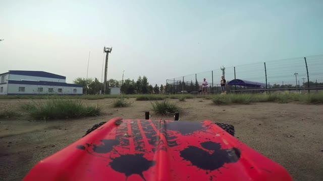 RC Cars With A Camera Rides On The Field And Filmed The Other Radio-controlled