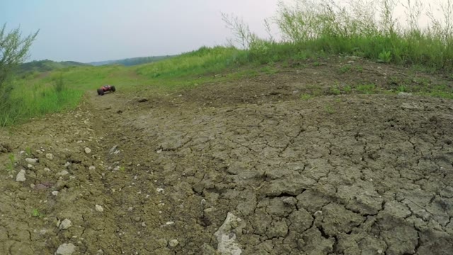 Radio-controlled Machine Rides On The Dirt Road