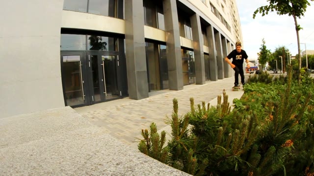 Skateboarder Jumping In The Center Of Summer City