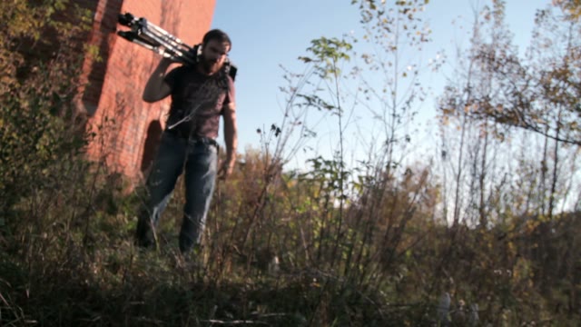 Man Walks With Retro Camera In The Wood