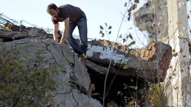 Man Climbs Down Through The Ruins