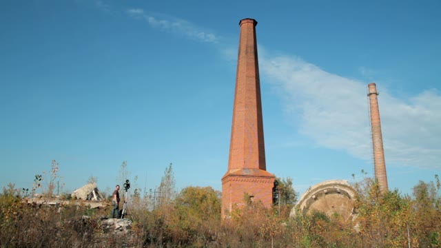 Man With Retro Camera Near The Chimney