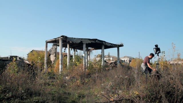 Man Photographs On Retro Camera Among The Ruins