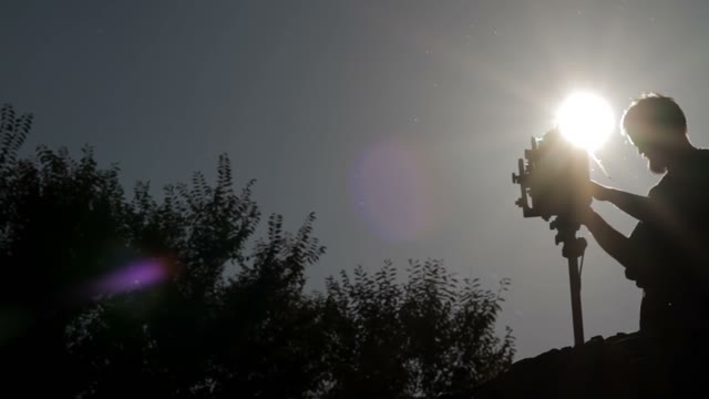 Silhouette Of A Man Adjusts The Retro Camera