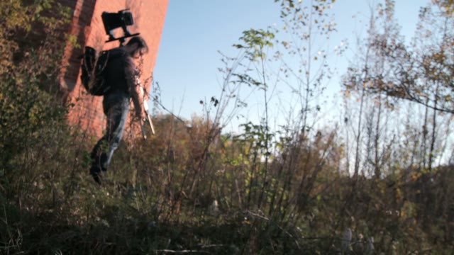 Man Sets Retro Camera In The Forest