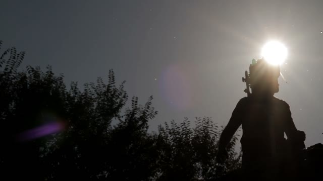 Silhouette Of A Man Adjusts The Retro Camera