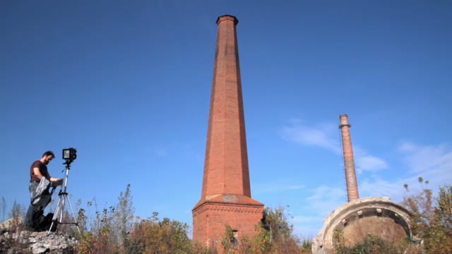 Man With Retro Camera Near The Chimney