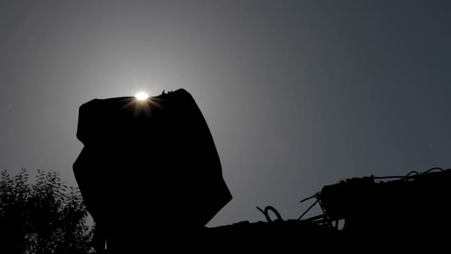 Silhouette Of A Man Adjusts The Retro Camera