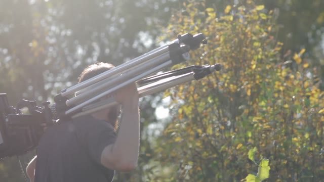 Man Walks With Retro Camera In The Wood