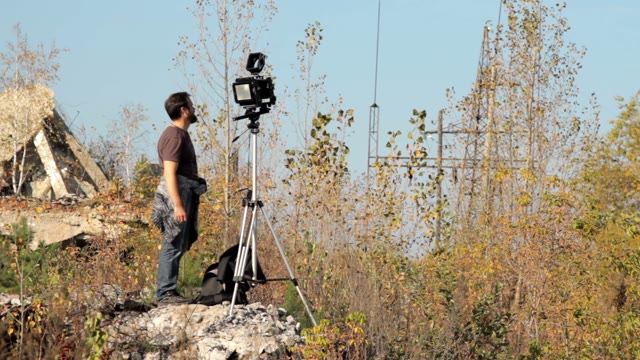 Man With Retro Camera Among The Ruins