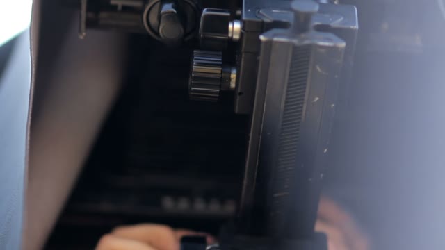 Man Adjusts The Retro Camera Close-up