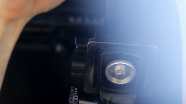 Man Adjusts The Retro Camera Close-up
