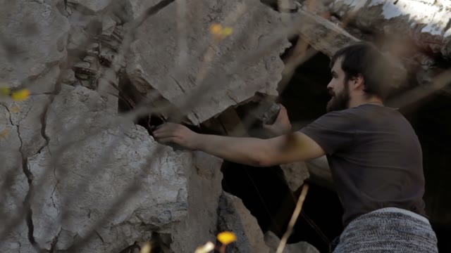 Man Climbs Upward Through The Ruins
