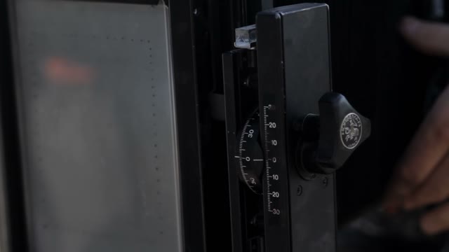 Man Adjusts The Retro Camera Close-up