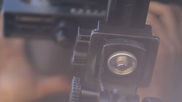 Man Adjusts The Retro Camera Close-up