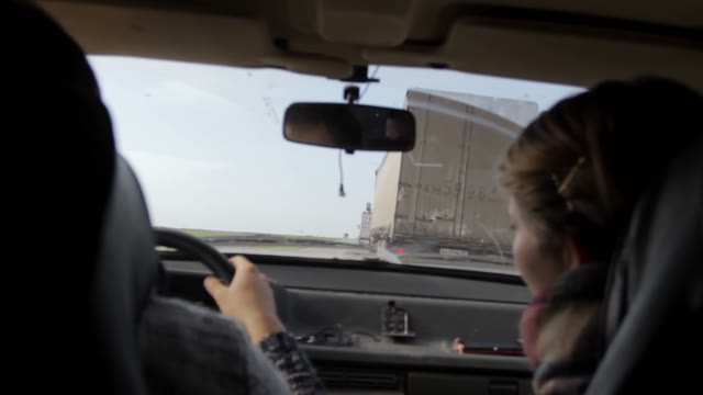 View From A Moving Car Overtaking Trucks