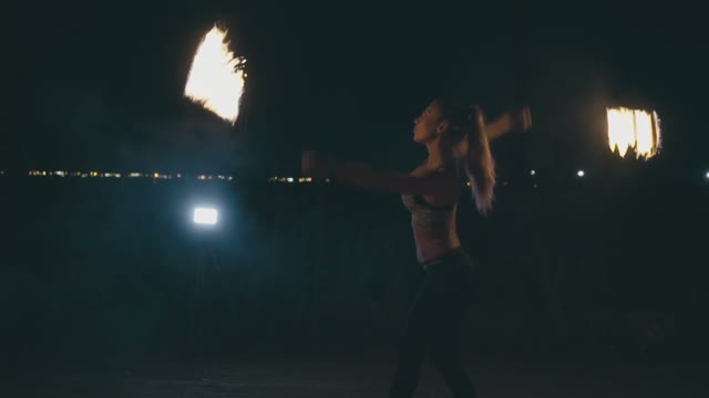 Pretty Blond Woman In A Fire Show At Night