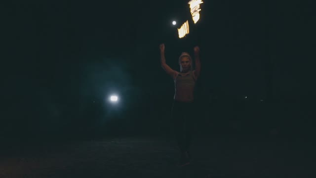 Attractive Blond Woman In A Fire Show At Night