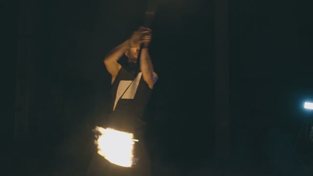 Brave Muscular Guy In A Fire Show At Night